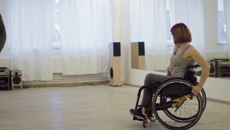 beautiful woman with paralyzed legs dancing in wheelchair