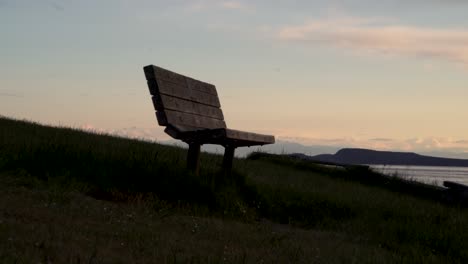 waterfront wooden bench in the early morning at washington park in anacortes, usa. - wide shot