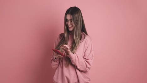 happy standing young woman preparing message on smartphone