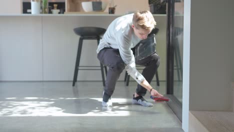 low shot of floor plan specialist measuring a wall in this bright stunning modern home