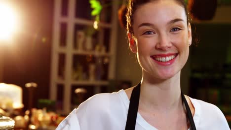 Portrait-of-waitress-standing-at-counter