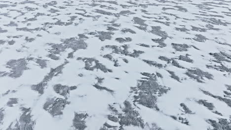 drone shot of snow drifts on frozen lake michigan