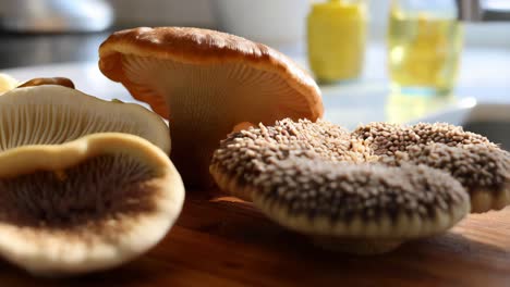 assortment of fresh mushrooms on a wooden cutting board