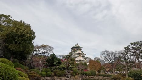 panoramic view of osaka castle with serene garden.