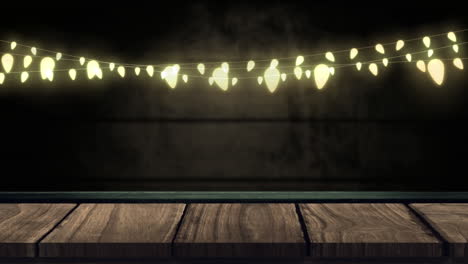 Glowing string of fairy lights on brick wall