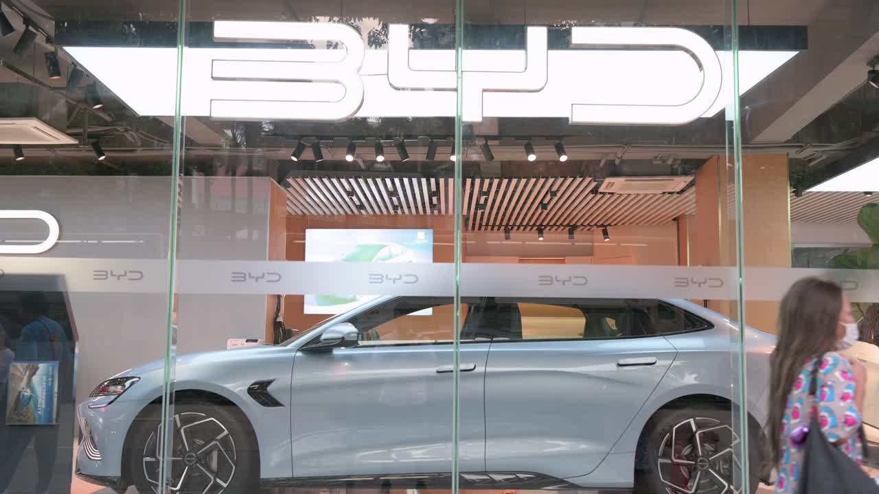 People walk in front of BYD’s official authorized dealership store, a prominent Chinese automaker.