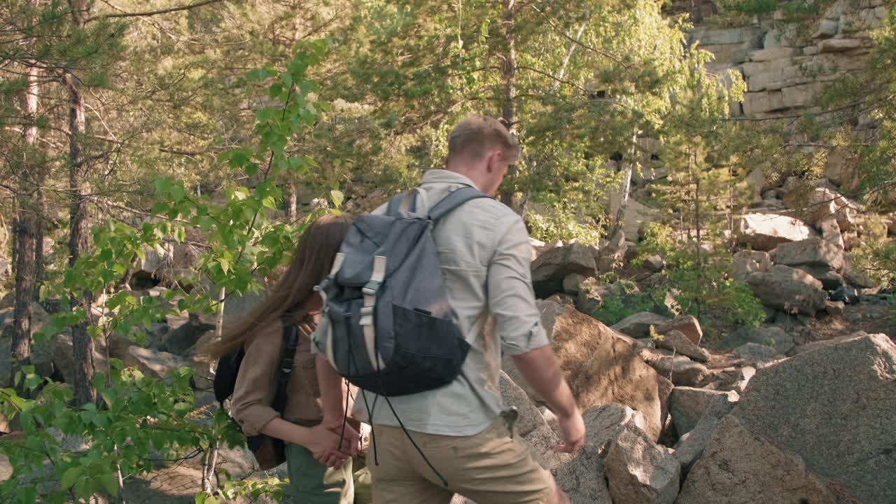 Slowmo of Couple Hiking in Hard Terrain
