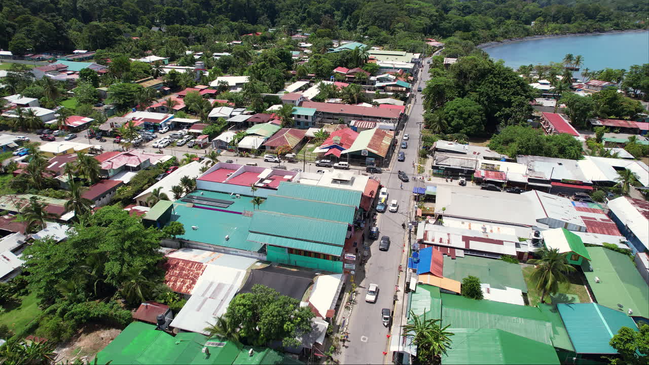 Overhead of a busy road with taxis and tourists in downtown Puerto Viejo, a popular travel destination and economically important port along the lush Caribbean coast of Costa Rica.