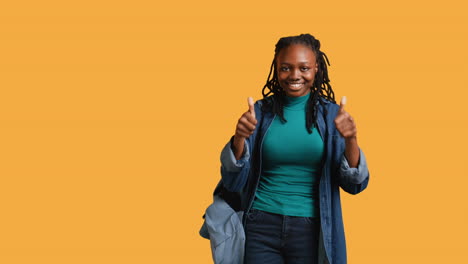 Happy-girl-doing-thumbs-up-hand-gesturing,-studio-background