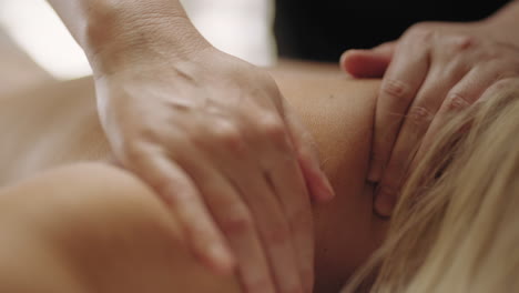 massage of neck collar zone in chiropractic clinic closeup view of physician hands on body of patient