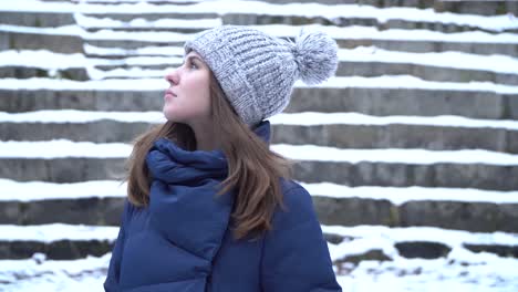 woman looking up at snowy stairs