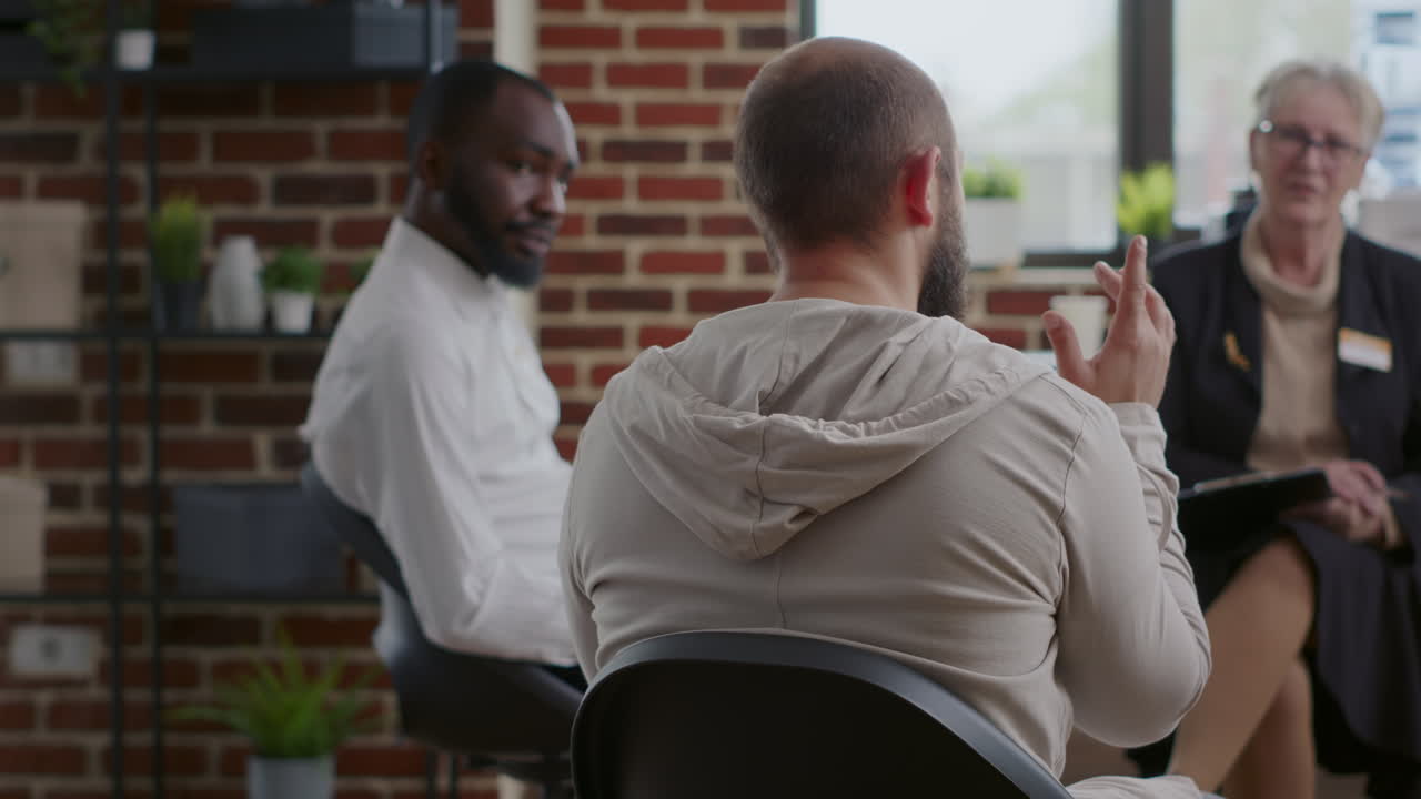 Close up of man complaining about alcohol addiction at aa support group therapy