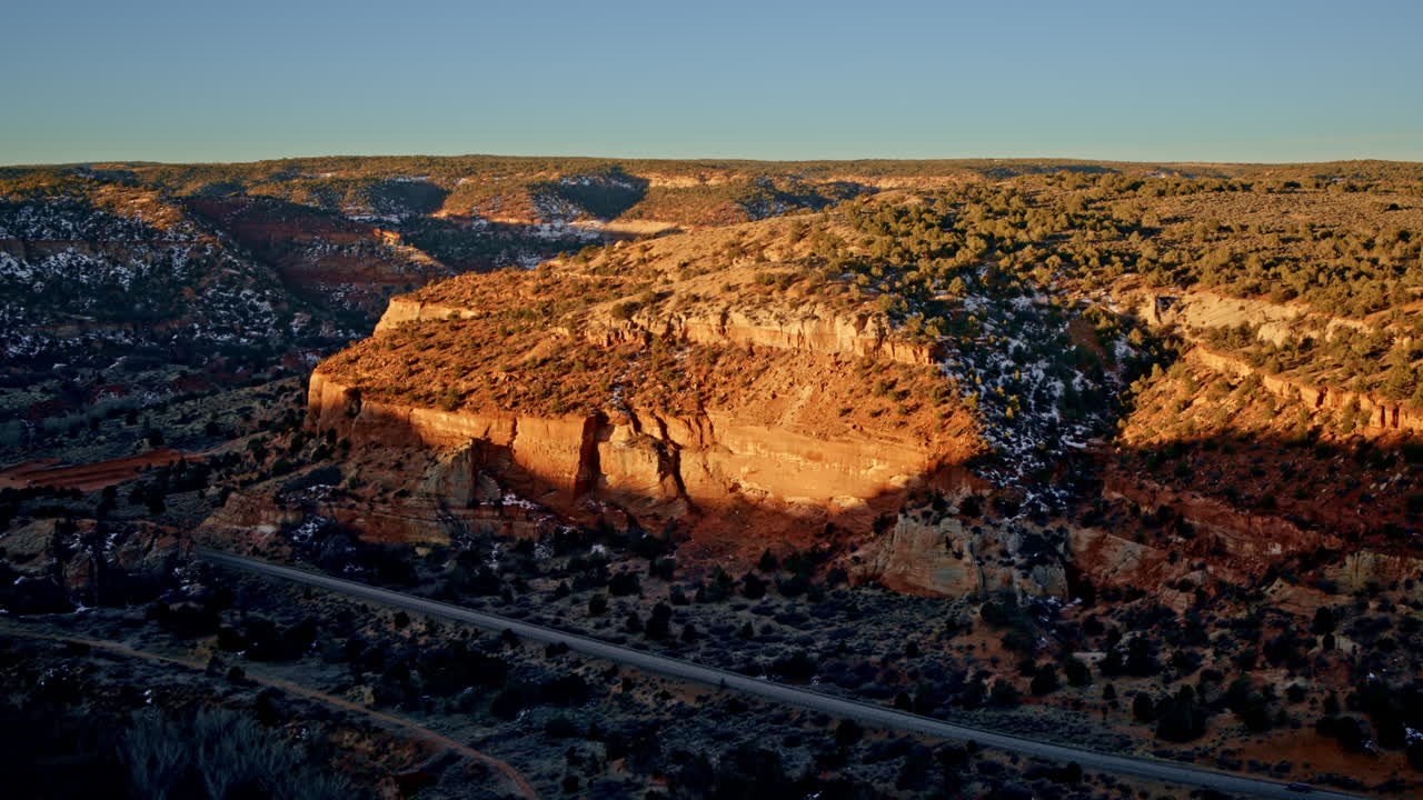 Overhead drone shot of the vast Canyonlands near Kanab, Utah, glowing in the dawn’s light.