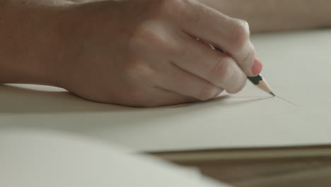 a woman uses a pencil to make a sketch