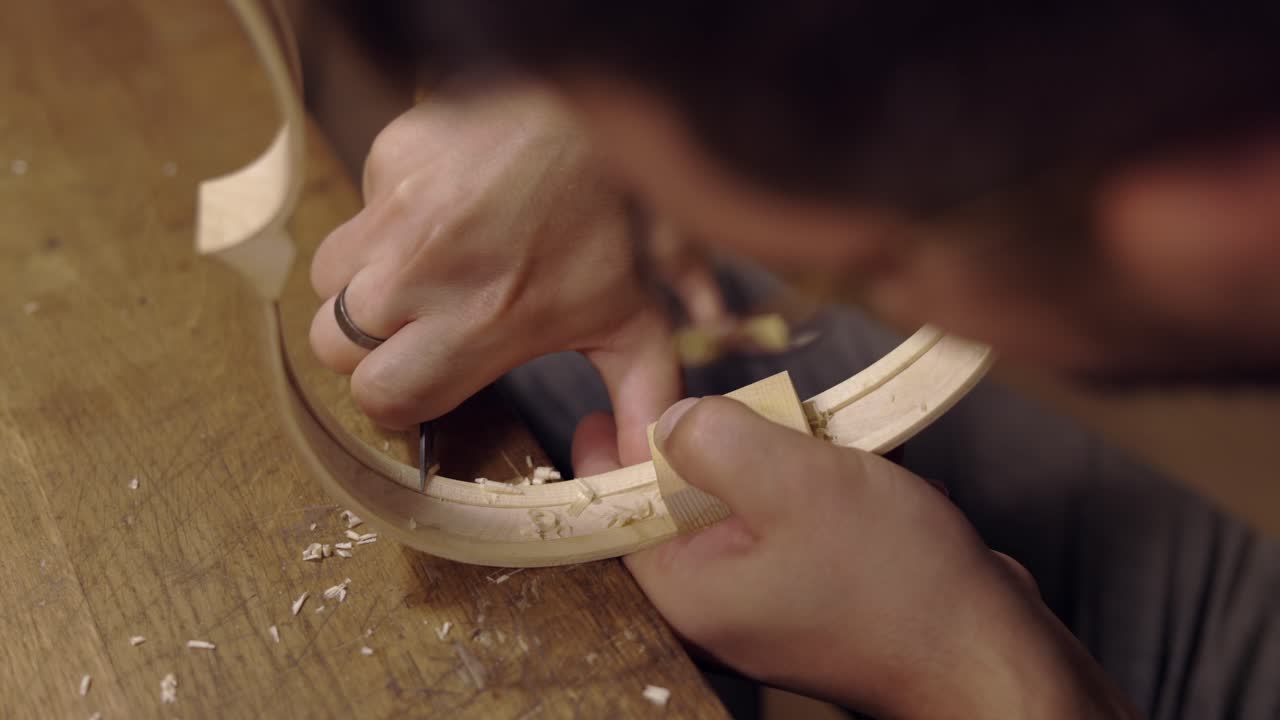 Anonymous luthier creating violin ribs in workshop