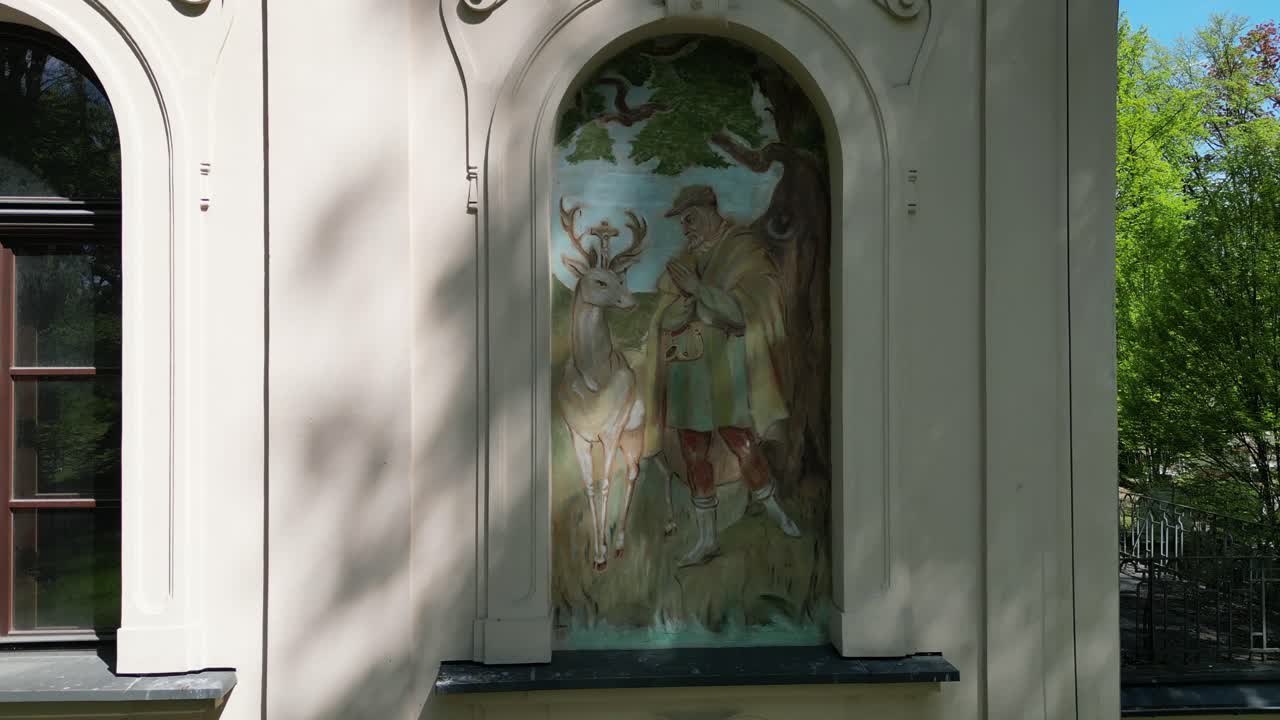 Artwork in the window of the facade of an old castle in Zywiec - drone 4K