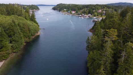 The-bay-harbor-of-Bamfield-British-Columbia,-boats,-trees,-and-houses-along-the-water