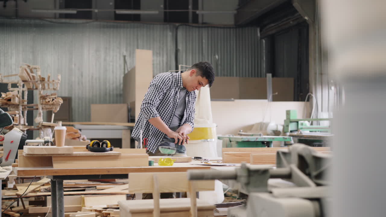 Woodworker Sanding Wood in Workshop