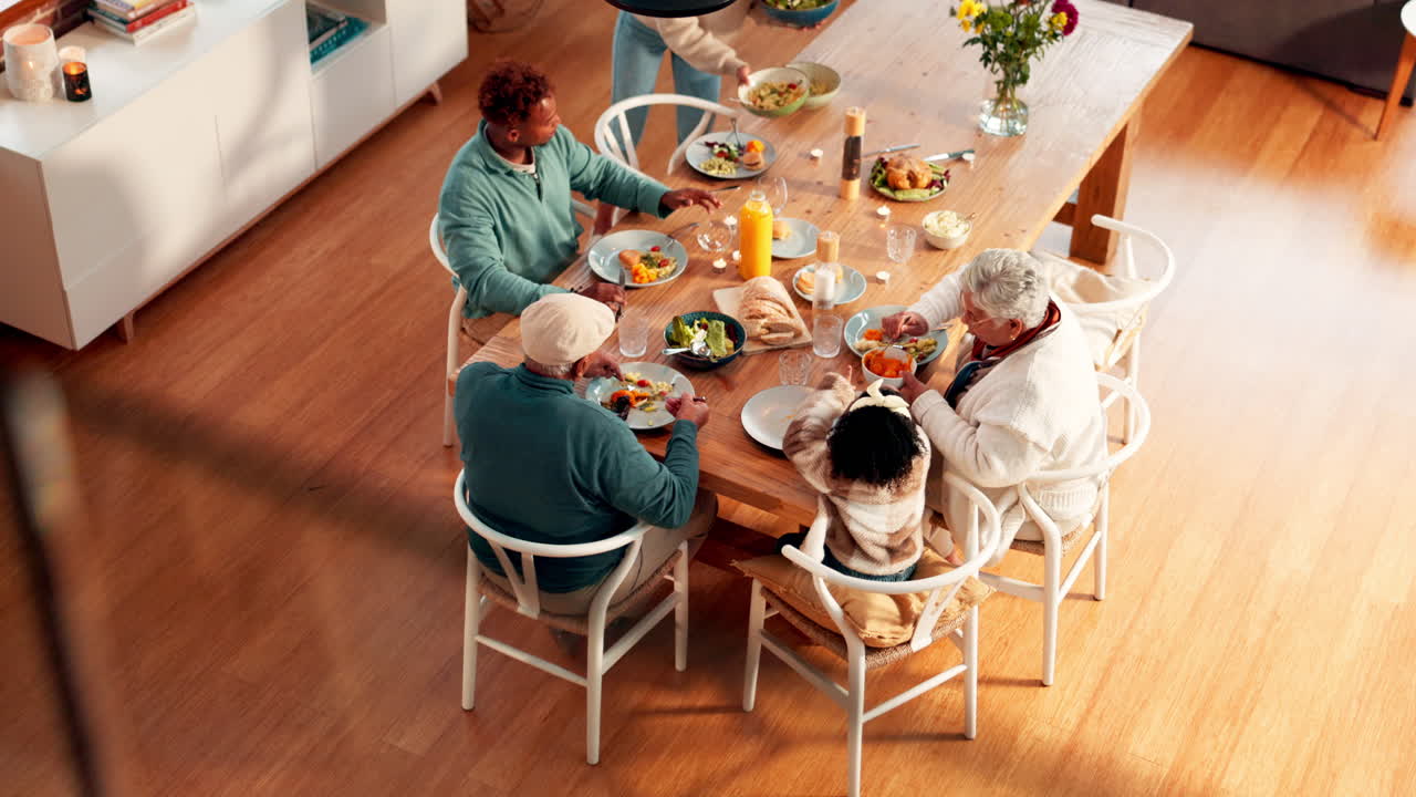Overhead View of Multi-Generational Family Eating Meal Together at Home
