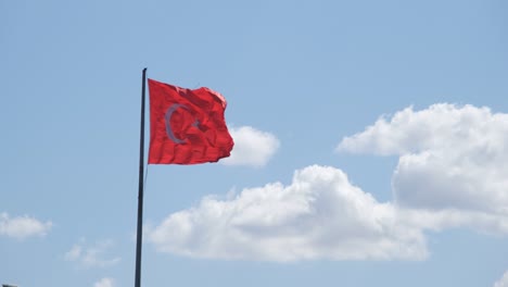 waving turkish flag, turkish flag waving in front of steady clouds