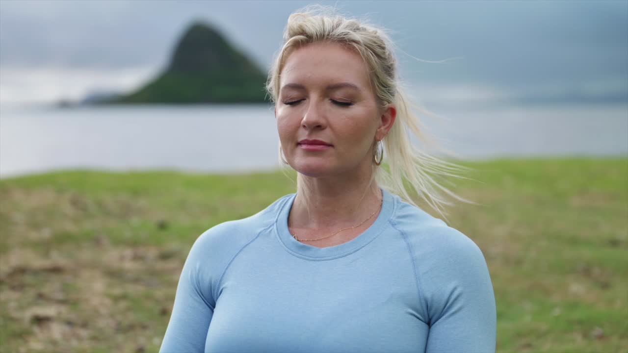 Female deep breathing in fitness attire, close up
