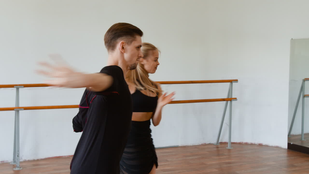 Elegant Ballroom Dance Couple Practicing in a Studio
