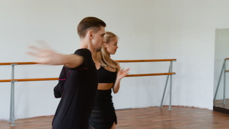elegant ballroom dance couple practicing in a studio