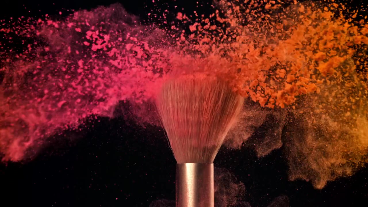 Vibrant Pink and Orange Powder Exploding from Makeup Brush in Slow Motion
