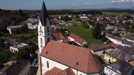 drone flies by a church in austria -steinakirchen am forst