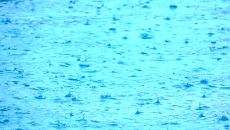 slow motion rain falling on ground, close up view