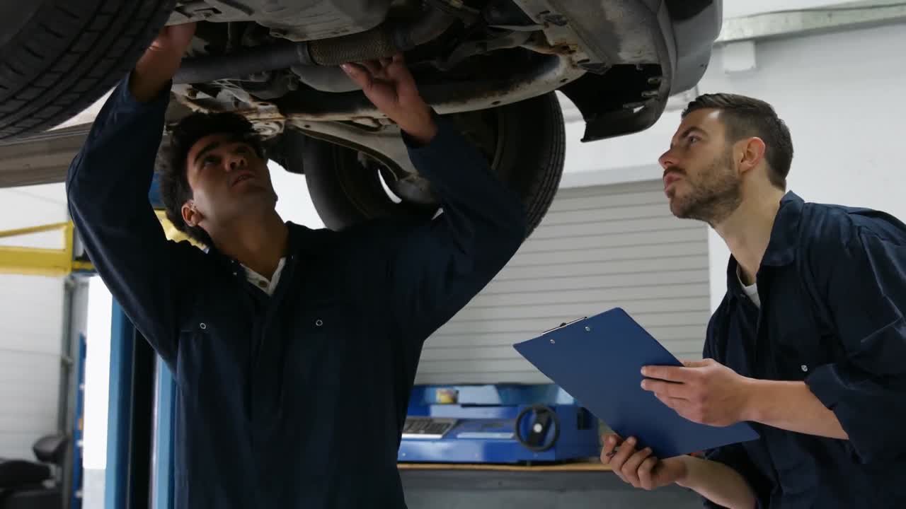 un guapo mecánico revisando un coche