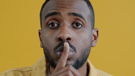 man with finger on lips