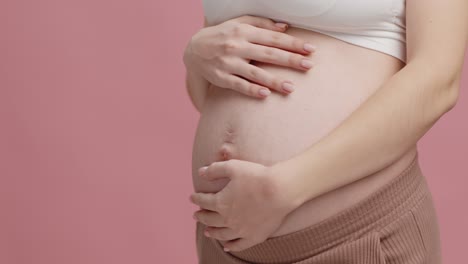 pregnant woman touching her belly