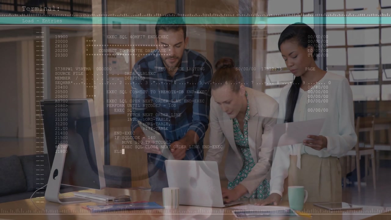 Tech team meeting around laptop typing command revealing translucent code overlay fixing data error