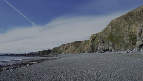 Ireland slow flight up deserted beach pebbles sea and cliffs Copper Coast Waterford Ireland epic locations