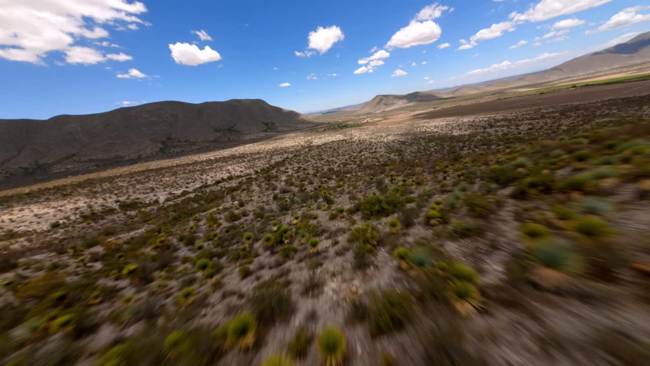 FPV DRONE SHOT OF A MOUNTAIN AND VALLEY IN THE DESERT OF COAHUILA IN MEXICO