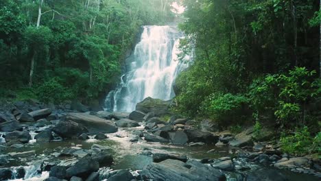 slow motion aerial shot of river and waterfall in green forest of brazil