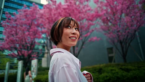 woman admiring cherry blossoms in japan