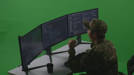 Side View Of Happy Asian Man Soldier Developer Celebrating And Dancing While Write Code With Multiple Computer Screens In Green Screen Studio