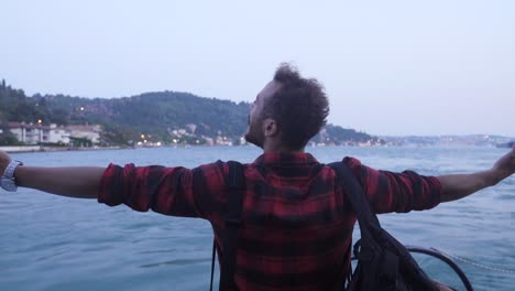 man opening his hands with happiness on the ferry.