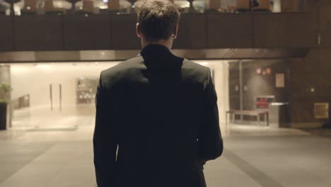 businessman walking through hotel lobby