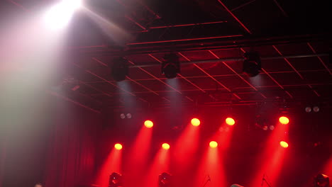stage lights illuminating a vibrant concert atmosphere with dynamic red and white hues