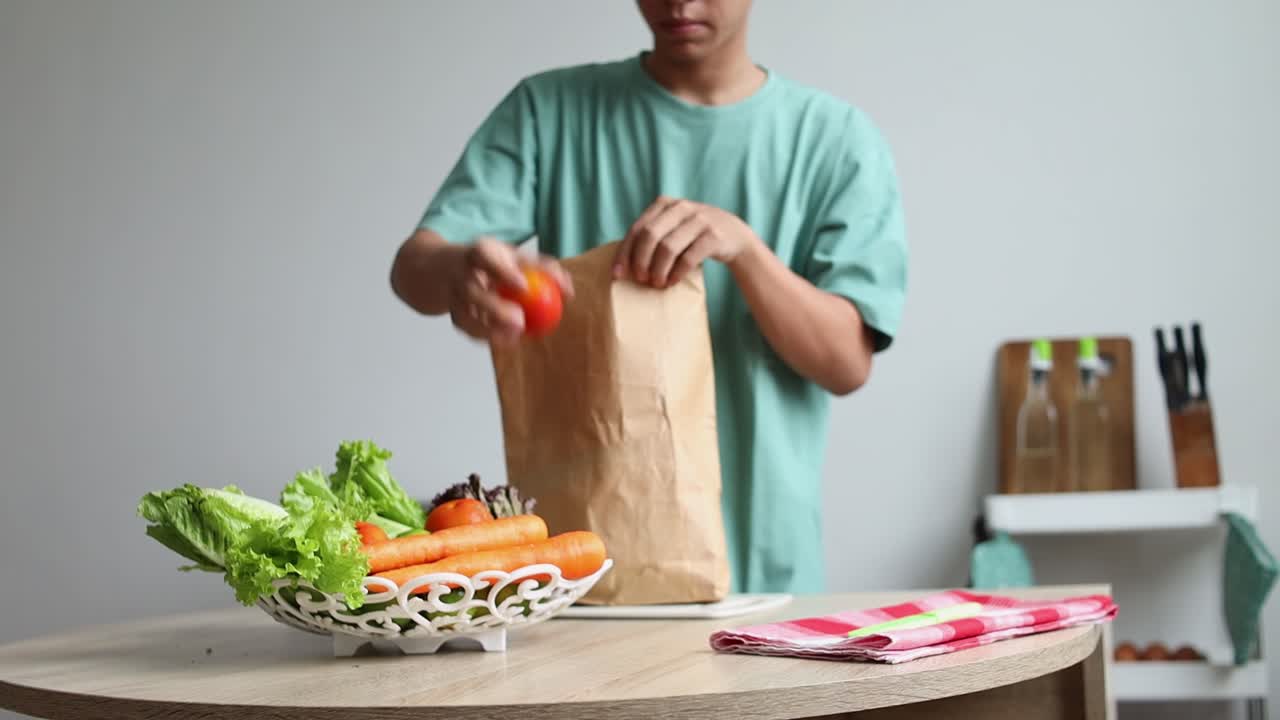 Man Unpacking Groceries and Preparing Vegetables in Kitchen