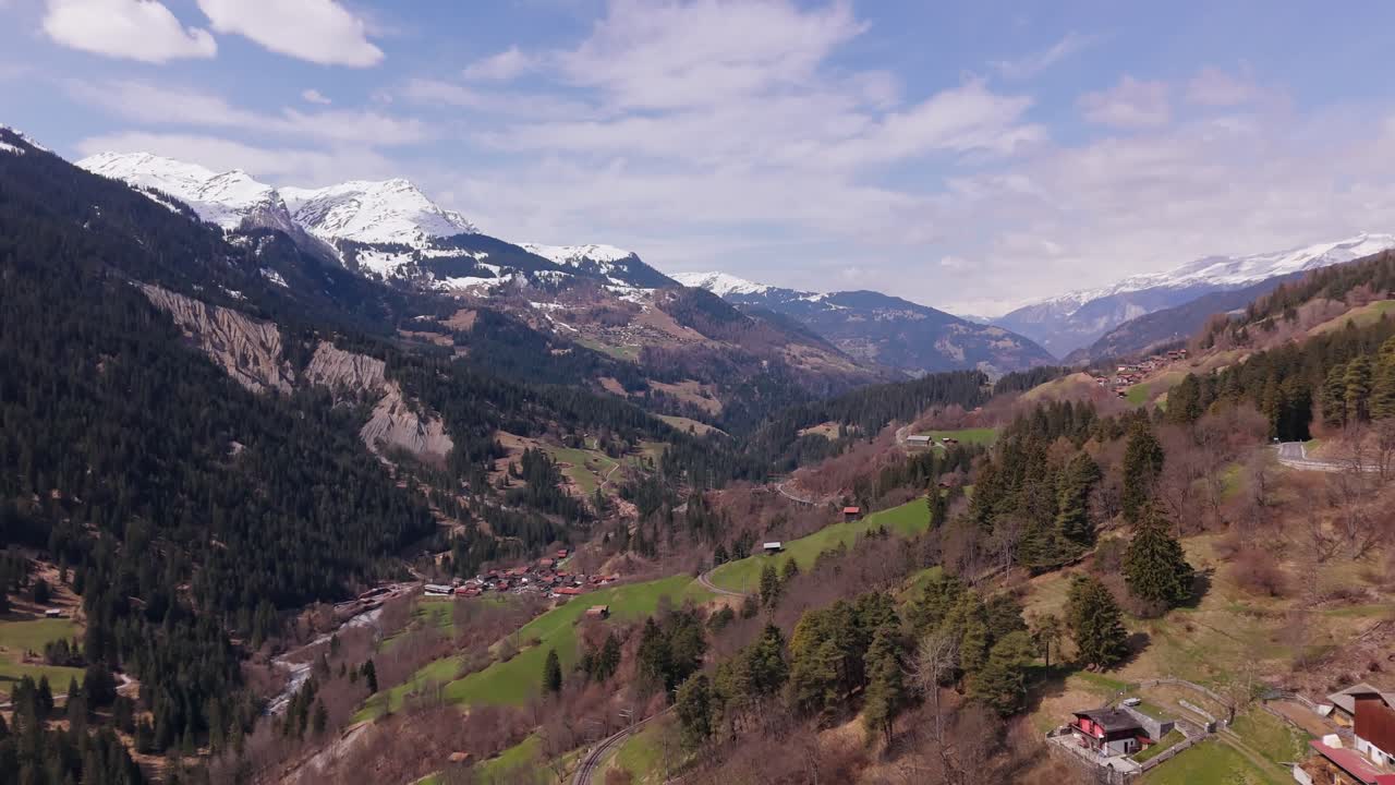 Scenic aerial view of mountains, forest, and village in Peist, Switzerland