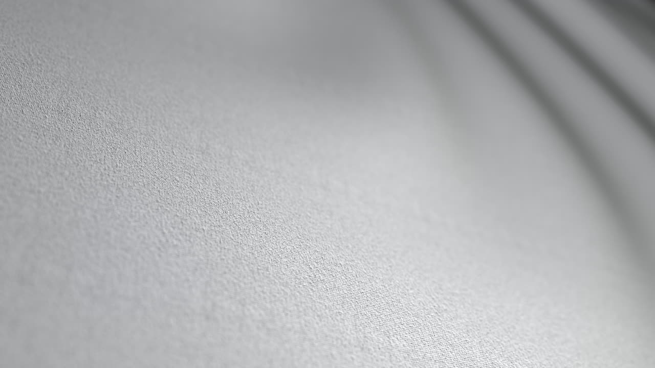 Abstract white textile motion with soft rippling folds