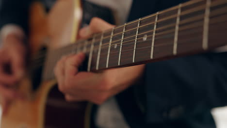 hands, musician and playing on guitar strings