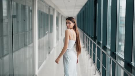 Stylish-adult-girl-in-pants-and-a-blouse,-beautifully-dissipates-long-hair