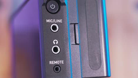 close up side view of the on-camera monitor with microphone, remote, and headphones sockets. action. details of professional studio shooting equipment