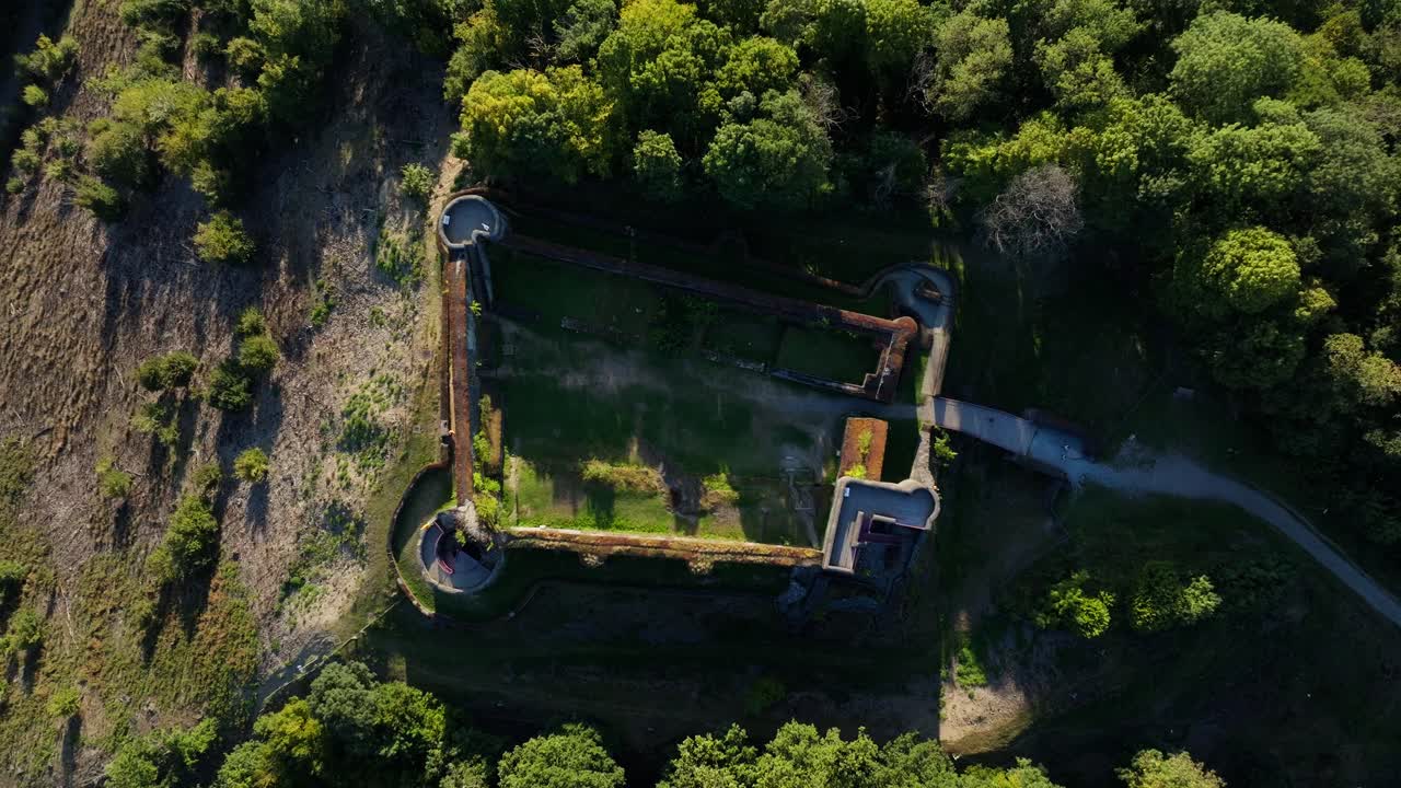 Aerial view of a fortress surrounded by forest