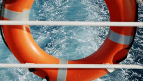 back of ferry/boat with a life saver ring float and view of water